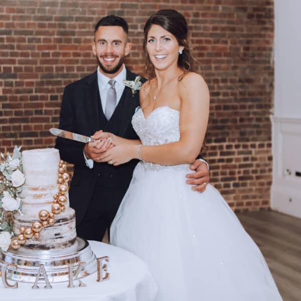 Newly Wed Couple Cutting Wedding Cake at One Warwick Park