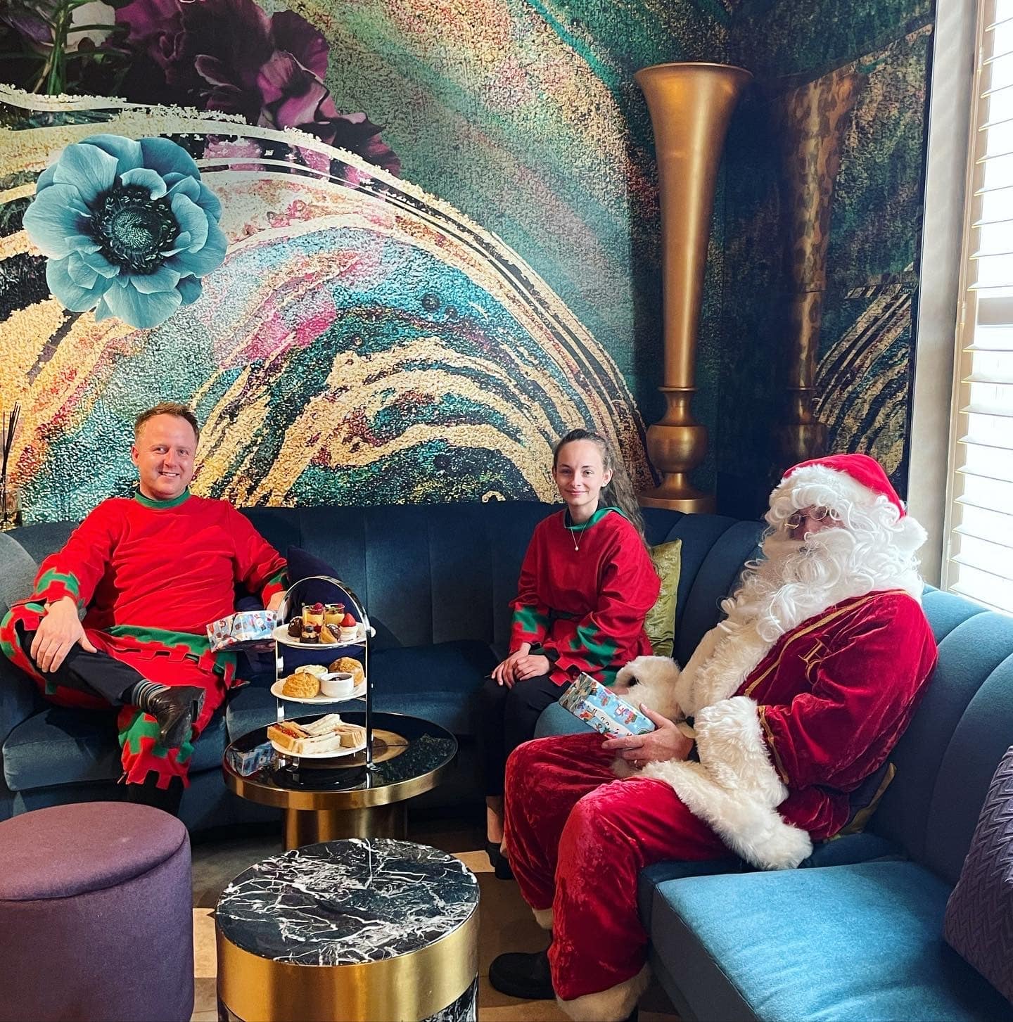 Father Christmas and his elves have an afternoon tea.