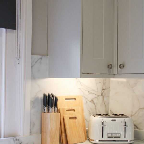 Kitchen countertop with knifes, chopping boards and toaster