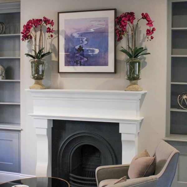 Chimney with two flower pots and a painting on top of it