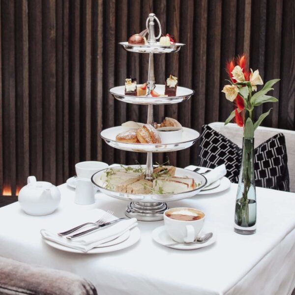 Table set with afternoon tea, snacks and coffee