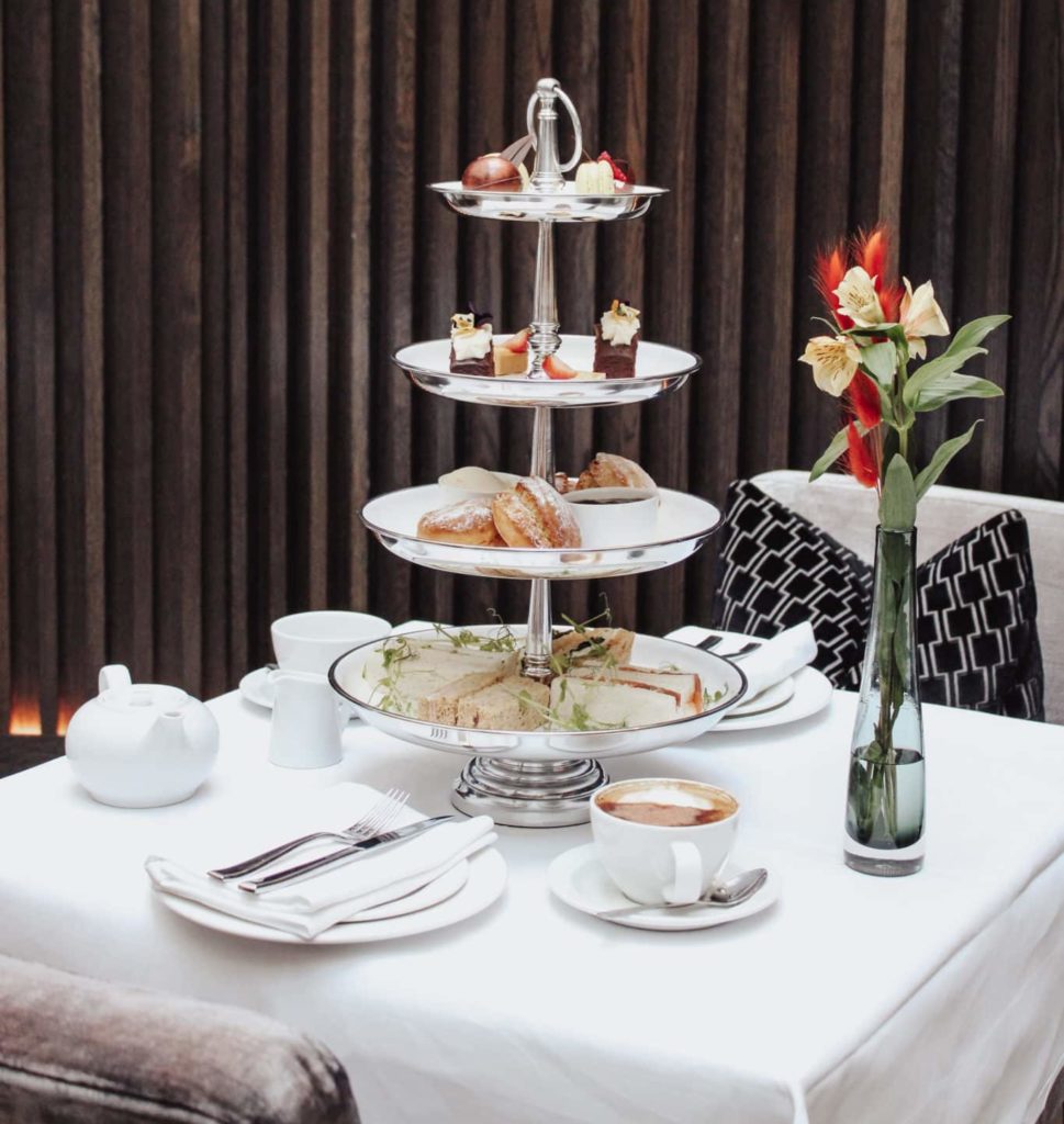 Table set with afternoon tea, snacks and coffee