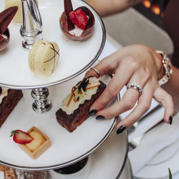 Hand picking a pastry from a plate