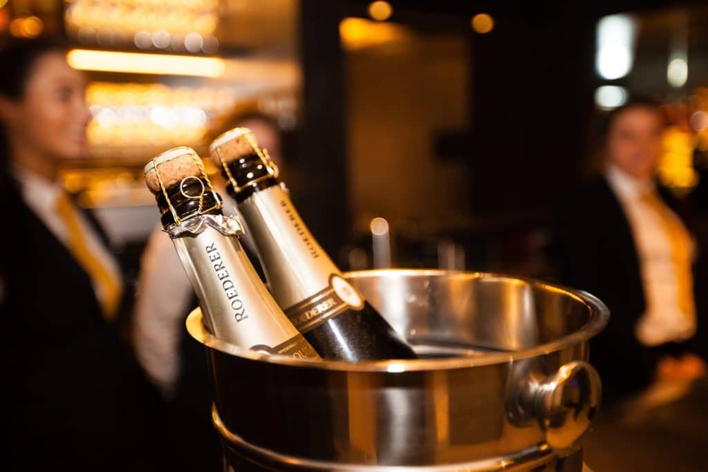 two bottles of roederer champagne sit in a champagne cooler