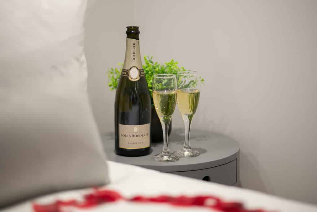Bottle of Louis Roederer and two champagne glasses