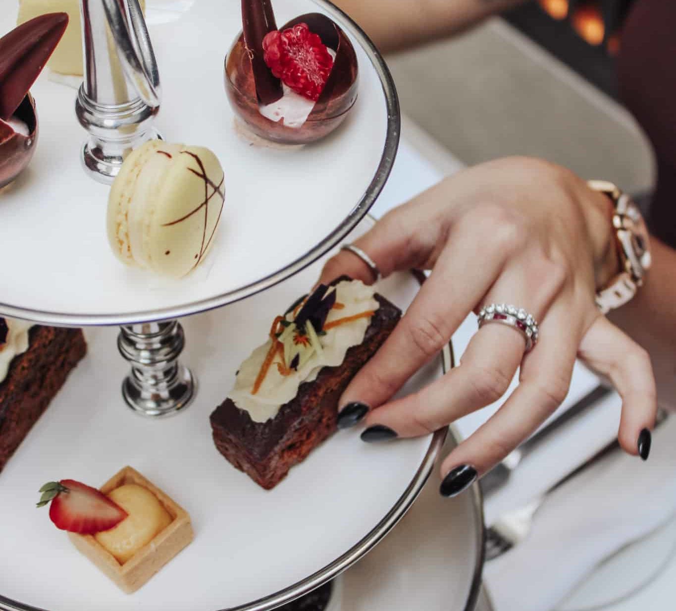 Hand picking a pastry from a plate