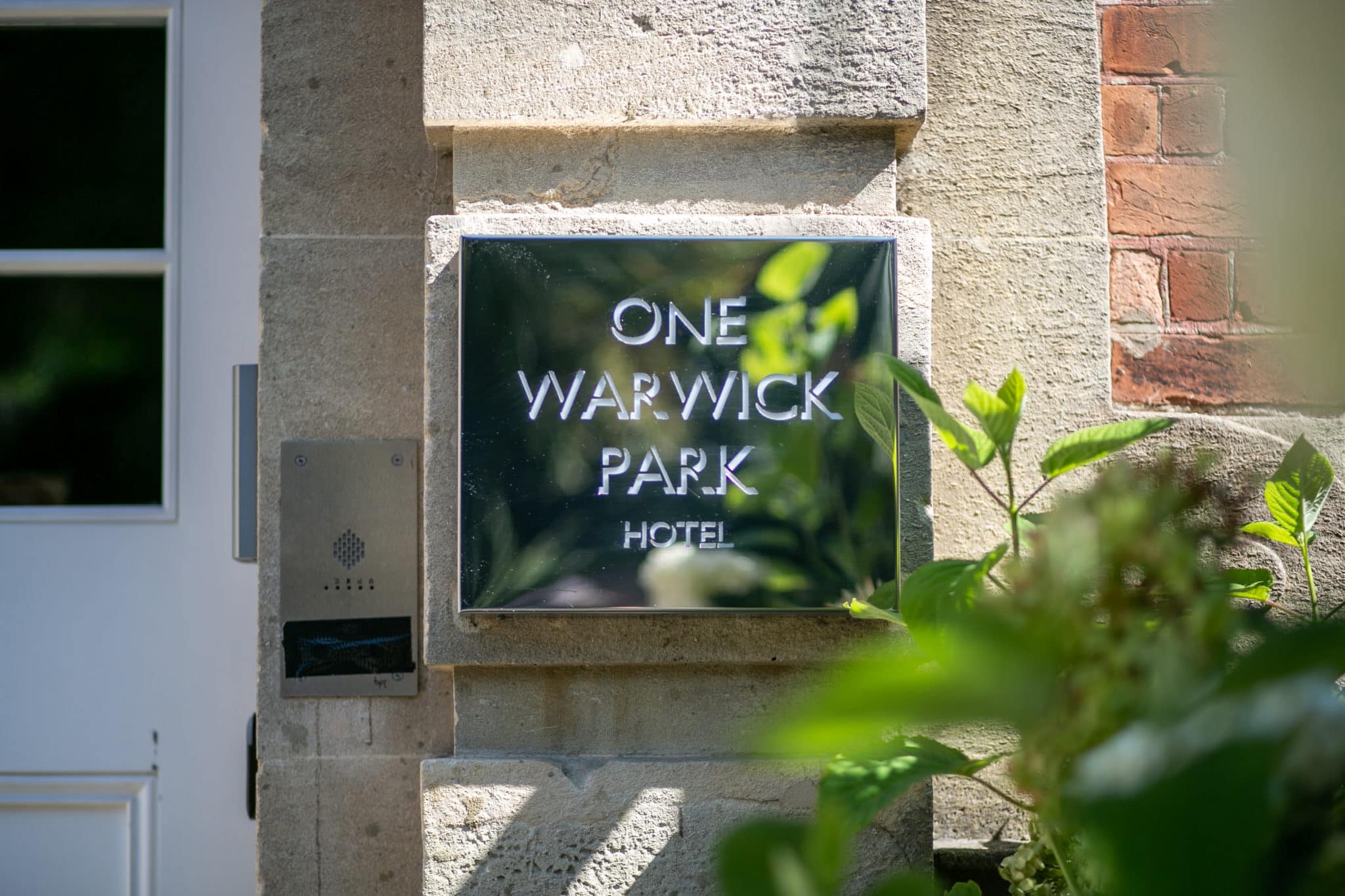 Plaque with "One Warwick Park Hotel" written on it