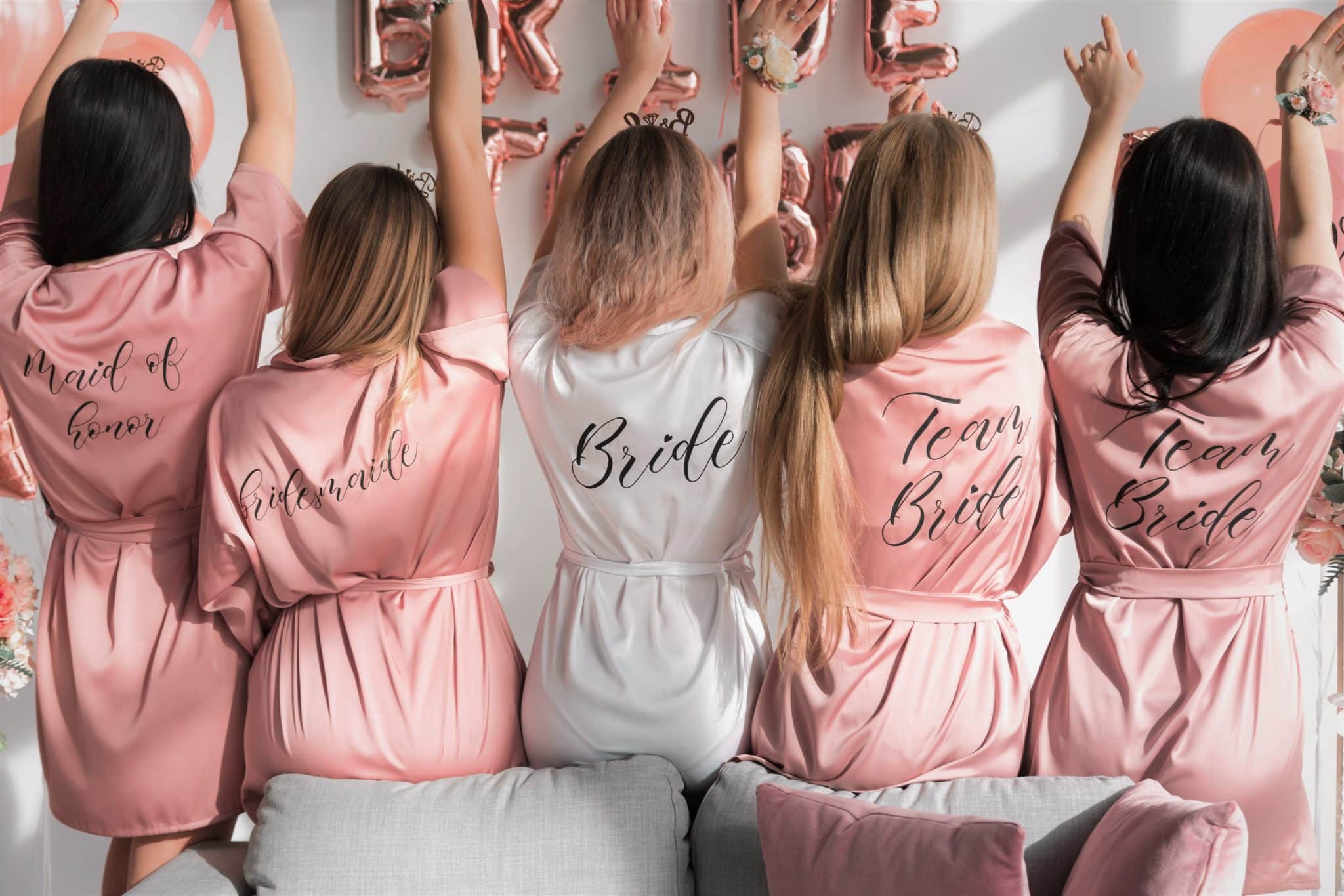 5 women at a hen party with hen party themed robes