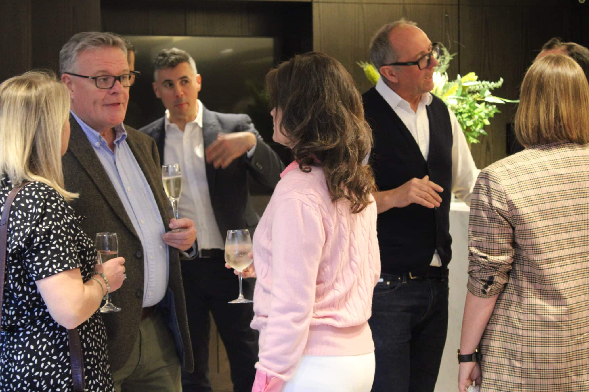 Local professionals networking at a business event in Tunbridge Wells, enjoying drinks and conversation in a relaxed setting.