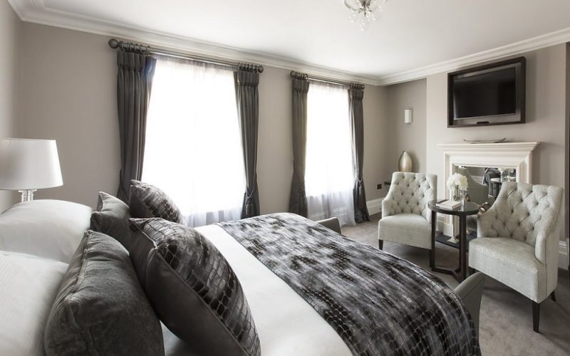 A bright, elegant hotel room with a king-sized bed, plush seating and natural light, showcasing premium accommodation available during Black Friday hotel offers in Tunbridge Wells.